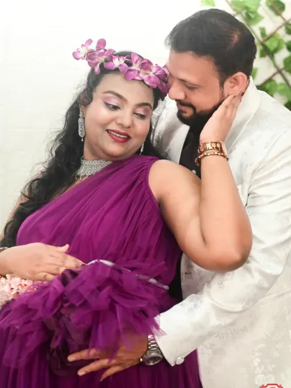 An intimate portrait of a couple during their maternity shoot. Our purple one-shoulder gown is designed to be both beautiful and comfortable.