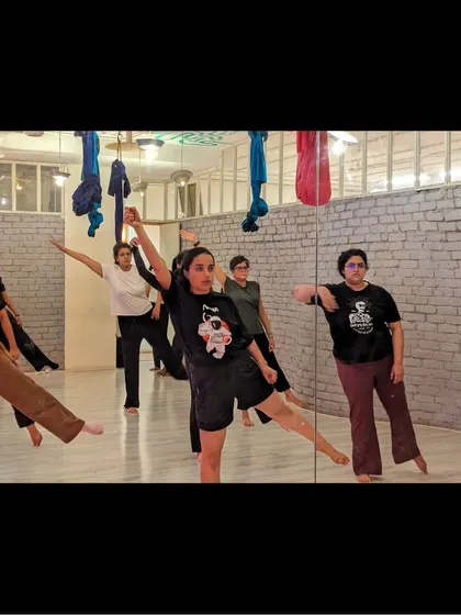 Students practice a balance and extension exercise, a key part of building a strong contemporary dance foundation.