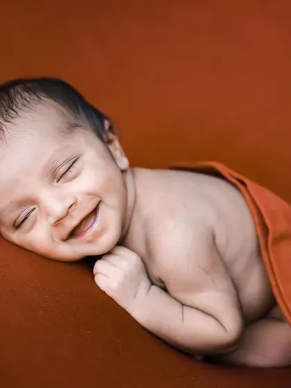 This joyful, full-faced smile is a rare and precious capture. We work to keep babies content and relaxed, which sometimes results in beautiful moments like this.