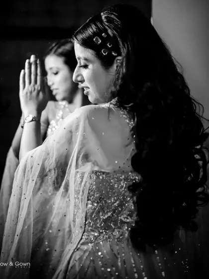 The black and white version of a creative engagement portrait. The focus on her reflection and the dramatic shadows create a timeless and artistic image.
