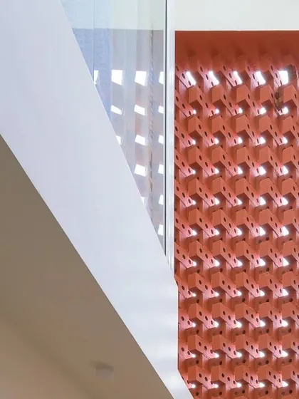 A detail of the brick facade, showing how the interplay of angles and voids creates a visually complex and interesting surface.