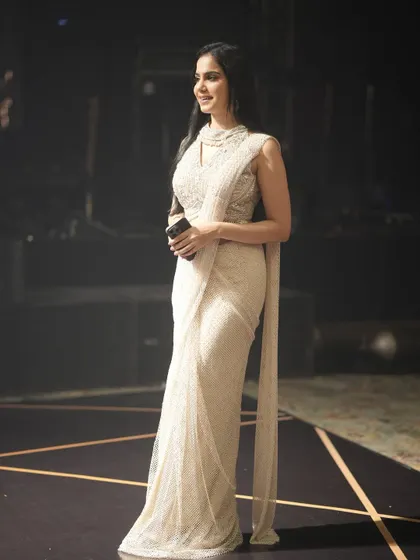Modeling a beautiful pearl-white pre-draped saree at an event in Siliguri. This look is the epitome of grace and sophistication.