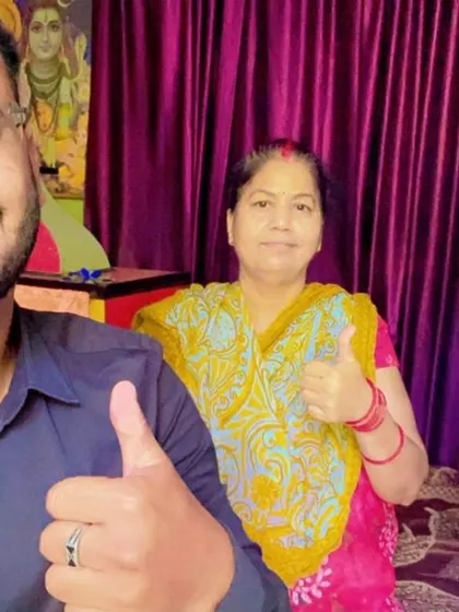 A couple gives a thumbs-up with our team member, happy with their decision to go solar.