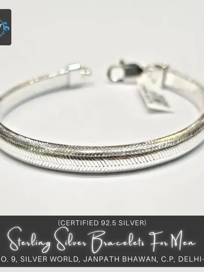 A sterling silver bracelet with a flat, herringbone-like pattern. This polished piece offers a sleek and modern alternative to traditional link chains.