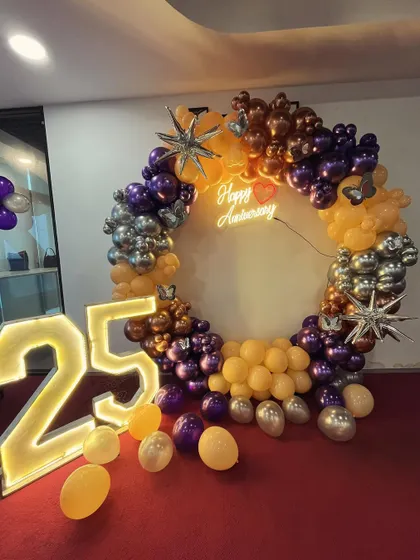 A clear, well-lit photo of the 25th-anniversary ring backdrop.