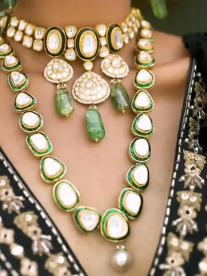 A detailed shot of the layered polki necklaces from the Om Jewellers cocktail look. Layering jewelry is a great way to create a statement, and here it adds depth and luxury to the ensemble.