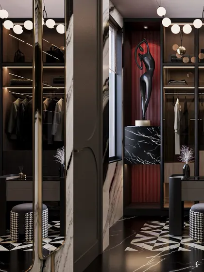 A detail of the wardrobe, where a sculptural art piece is highlighted against a red textured backdrop, adding a surprising pop of color to the monochrome space.