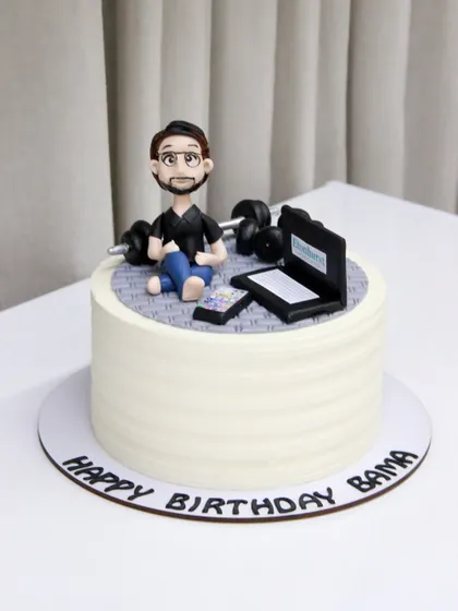 A cake for someone who loves to work hard and play hard. This design features a caricature working on his laptop while also having his workout weights nearby.