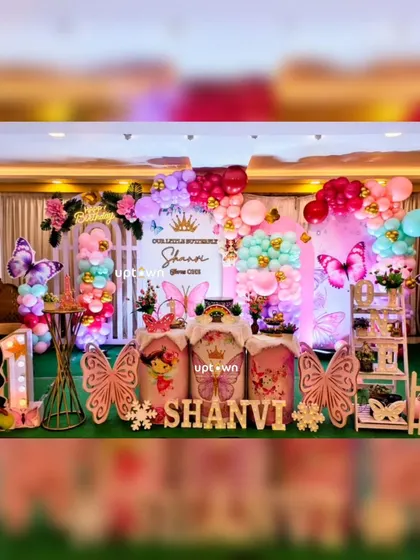 A vibrant butterfly theme for Shanvi's first birthday, with colorful character cutouts.