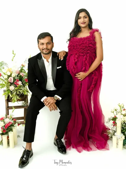 A formal and elegant couple's portrait. The vibrant gown and classic suit create a stunning visual, perfect for celebrating in style.