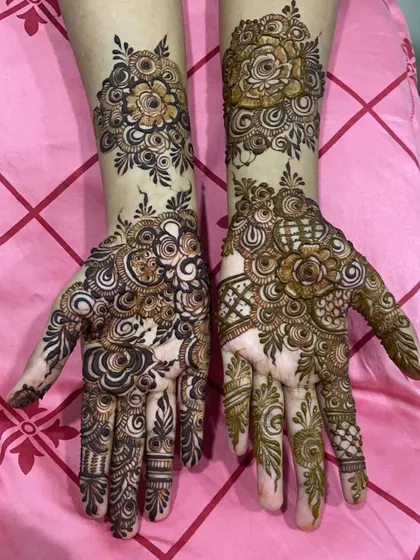 A clear, bright shot of the two different floral henna designs.