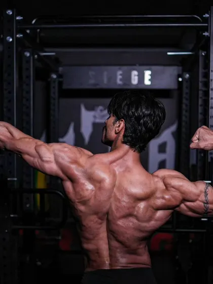 To infinity and beyond. A classic archer pose, showing off the full expanse of my back and arm development.
