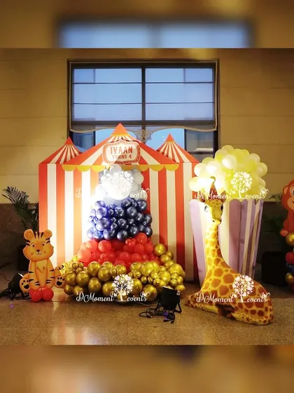 A fun photo corner at the carnival party, featuring a giant popcorn box made of balloons and friendly animal cutouts.