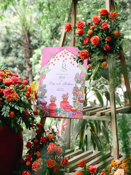 A custom-illustrated welcome sign for the Haldi, featuring a colorful, artistic design that ties into the overall theme.