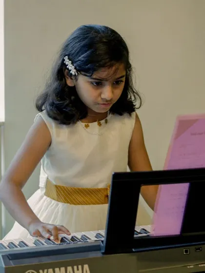 A young pianist concentrating on her piece during a student recital. The focus and dedication of our students is truly inspiring.