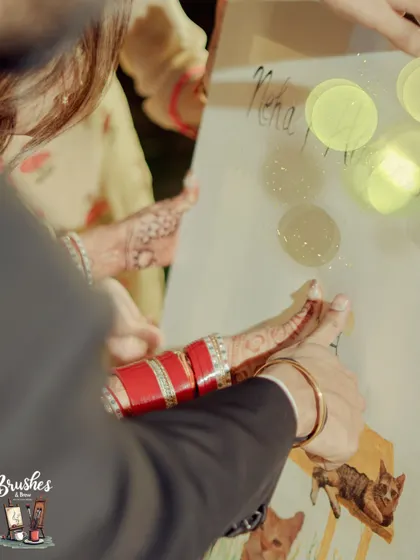 A close-up of the bride's father adding his thumbprint blessing to the canvas. Each print represents a wish of love and happiness for the new couple.