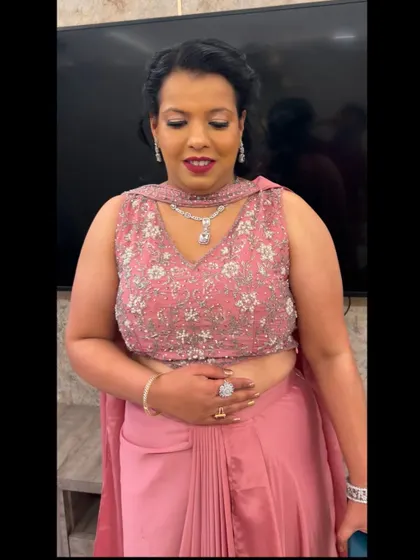 A close-up of the makeup for the client in the pink saree. The look is subtle yet glamorous, with a focus on defined eyes and a bold lip.
