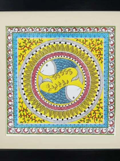 This circular Madhubani composition by Neha Kumari features two fish swimming in a yin-yang formation. The vibrant yellow and blue colors and leafy motifs create a lively and harmonious design.