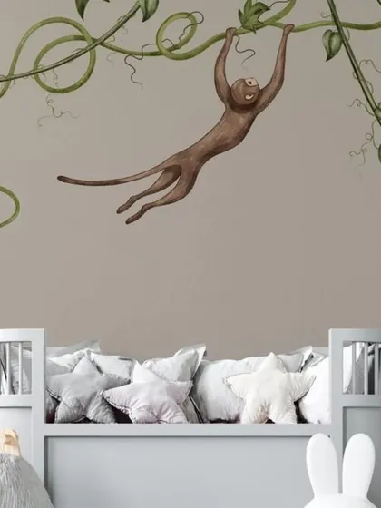 Another angle of the charming monkey and vine wallpaper, showing how it can create a feature wall in a child's bedroom.