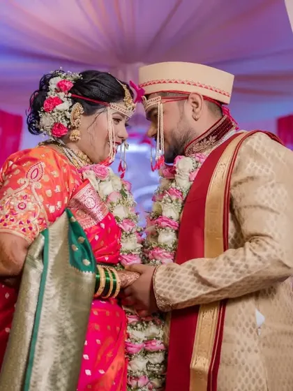 A classic romantic portrait of the couple, holding hands and sharing a loving gaze during their wedding ceremony.