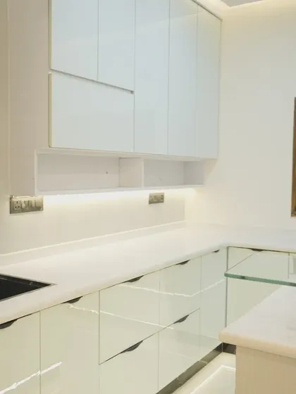 A closer look at the clean lines and seamless finish of the handleless cabinets. The under-cabinet lighting provides excellent task lighting while adding to the modern ambiance.