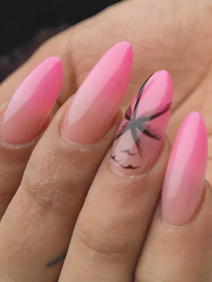 Vacation mode activated. A simple pink ombre design is elevated with a hand-painted palm tree silhouette, instantly giving these nails a tropical, beach-ready feel.