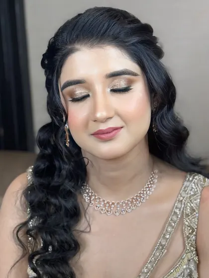 A close-up of the makeup, featuring a soft gold eyeshadow and a pretty pink lip.