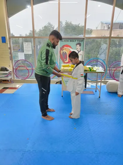 Tying a yellow belt.