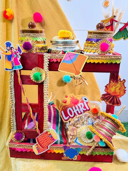 A closer look at the manji-style Lohri hamper, showing the festive details like kites, bonfire cutouts, and dhol motifs.