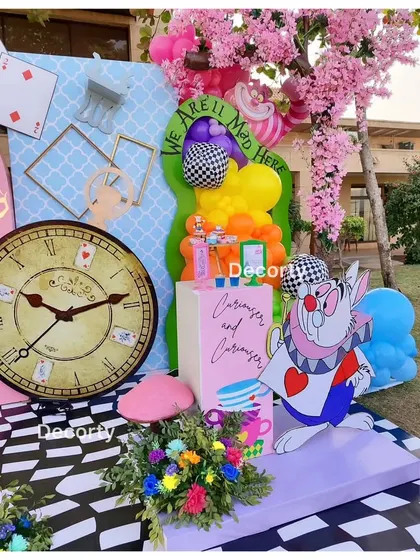 A close-up of the party decor, featuring the White Rabbit and a large clock.