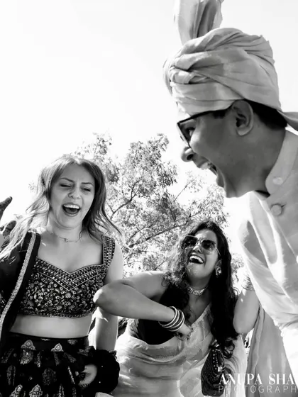 A black and white candid shot of guests laughing and dancing. Monochrome can capture the energy and emotion of a moment just as powerfully as color.