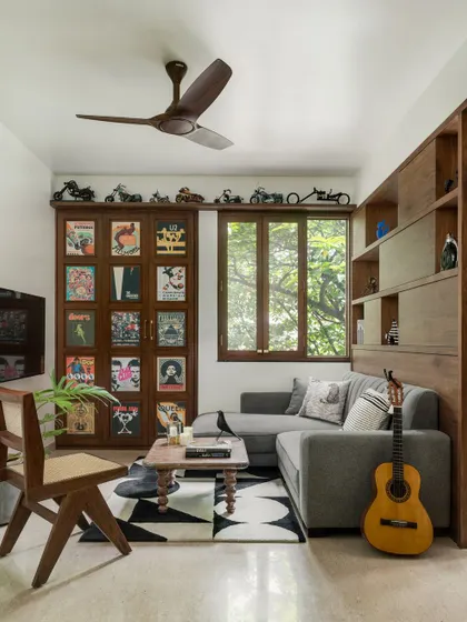 The family living room in our penthouse features a cozy L-shaped sofa and a hidden bar. The space is designed for relaxation and casual get-togethers.