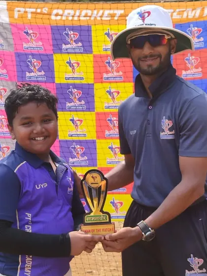 A happy U-10 player from the purple team is all smiles after being named Man of the Match.