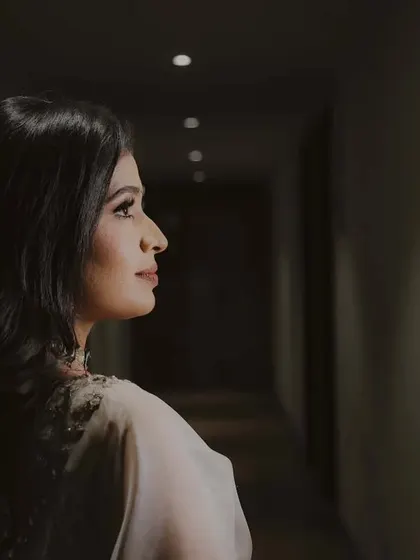 A beautifully lit profile shot of the bride-to-be. The dramatic lighting creates a sense of elegance and mystery.
