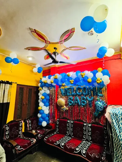 A full view of the living room decorated to welcome a new baby, showing the colorful and festive setup.