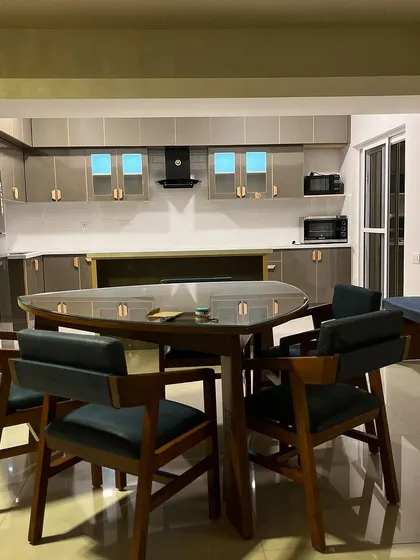 A view from the dining area into the open-plan kitchen. The design ensures a seamless flow between the spaces, perfect for modern living.