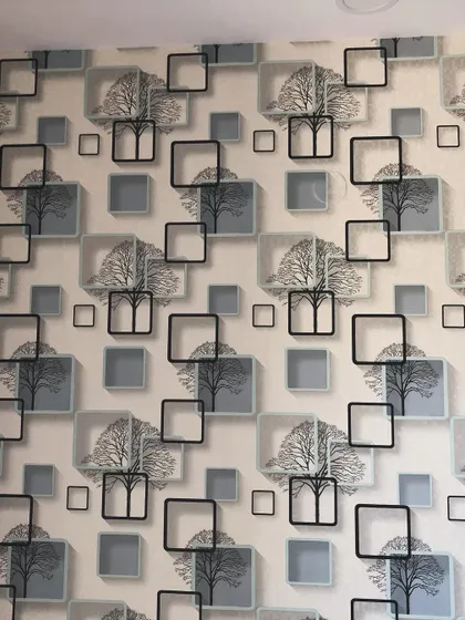 A close-up of the repeating pattern of the 3D tree and square wallpaper.