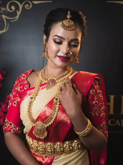The same beautiful red bridal blouse, shown here with full temple jewelry to complete the quintessential South Indian bride look.