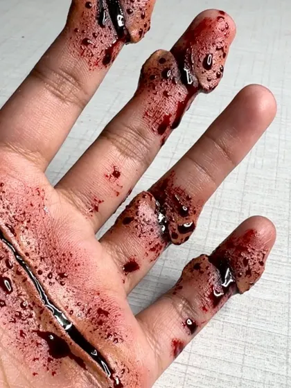 Another angle of the gory hand makeup, perfect for Halloween or film projects.
