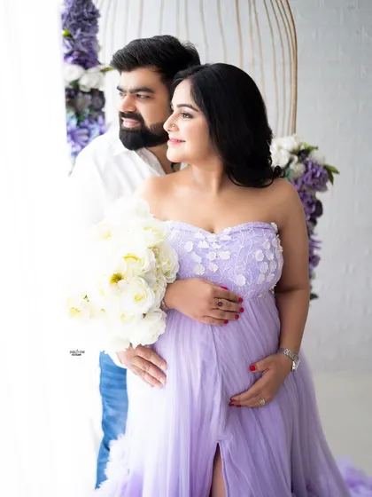 A sweet couple's portrait by the window. The floral birdcage prop creates a beautiful frame for this loving moment.