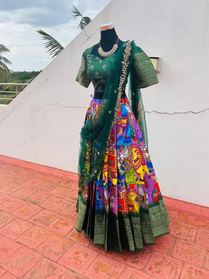 The vibrant colors and traditional art on this lehenga are stunning.