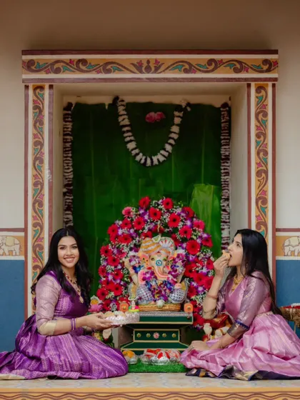 Two sisters celebrating in their custom gowns, both created by upcycling old sarees. It shows how we can create complementary yet distinct outfits for family members.