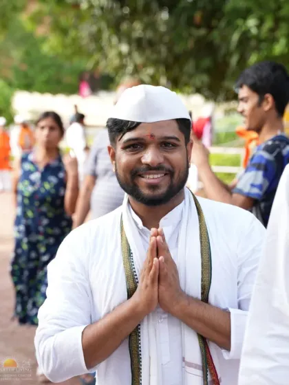 A devotee greets everyone with a warm smile and 'Namaste' during the Ashadi Ekadashi celebrations. The spirit of the day is one of open-hearted joy and gratitude.