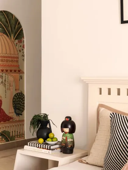 Another angle of the guest bedroom, showing the full hand-painted mural. This feature transforms the room, creating a unique and artful backdrop that tells a story of heritage and beauty.