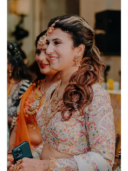 A candid shot from the event. Her makeup looks fresh and flawless, even in the middle of the celebration.