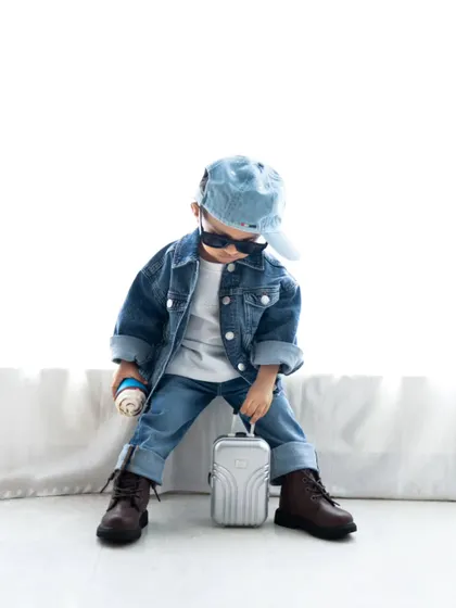 Ready to travel! This little guy is all set with his mini suitcase and coffee. Themed shoots are a great way to capture their imagination.