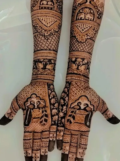 A traditional design featuring swan and peacock motifs, symbolizing love and beauty, set within intricate patterns covering the full arms.