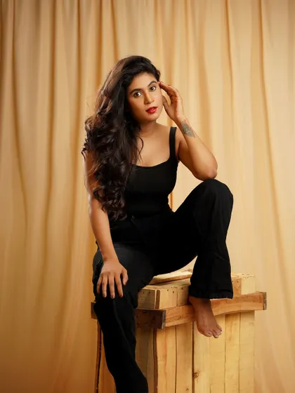 A simple setup with a black tank top and wooden crates. This portrait shows that you don't need a complex set to create a powerful image; it's all about the pose and the attitude.