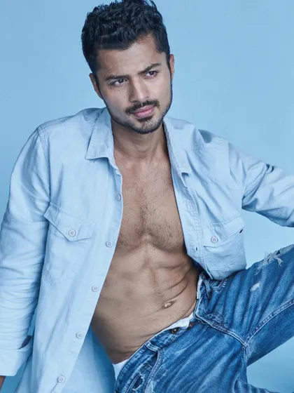 A relaxed, confident vibe in an open shirt and jeans, perfect for a lifestyle or fashion brand.