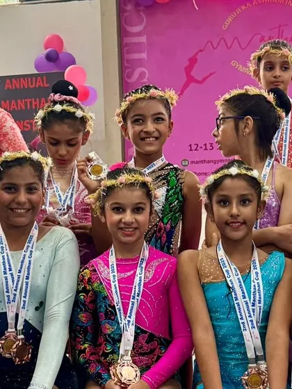 A team of champions. This group photo captures the joy and success of our gymnasts at the Manthan Gymnastics Cup, each one proudly wearing their well-earned medals.